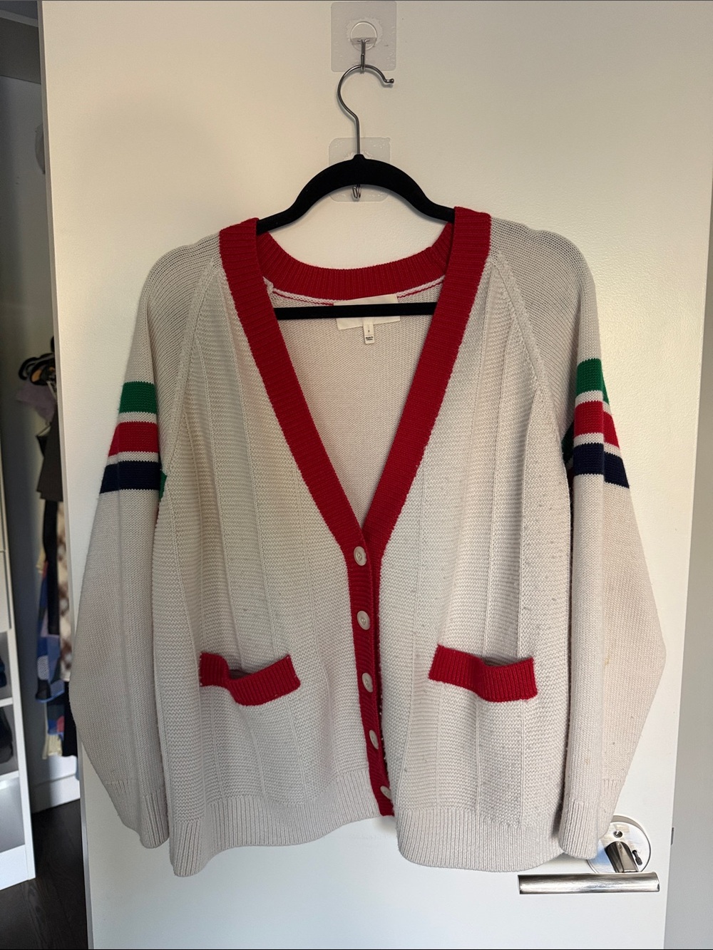 THE GREAT. Cream Cardigan with Red Trim and Green, Navy, Red Sleeve Stripes